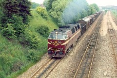 DSB MZ 1421 (type II) with freight train photographed in Fredericia heading for Århus. May 1975.  The MZ class (type I and II) was purchased from 1967 to 1970 in a number of 26. Only a few of these engines remain in service by DSB - most are now sold to other companies. MZ 1421 was deposited in 2002. Built by NOHAB and Frichs. Dieselelectric. Co'Co'. 2270 kW - 3300 hp. Max speed 143 km/h - 89 mph. Length 20 800 mm. Weight 116,5 metric tonnes.